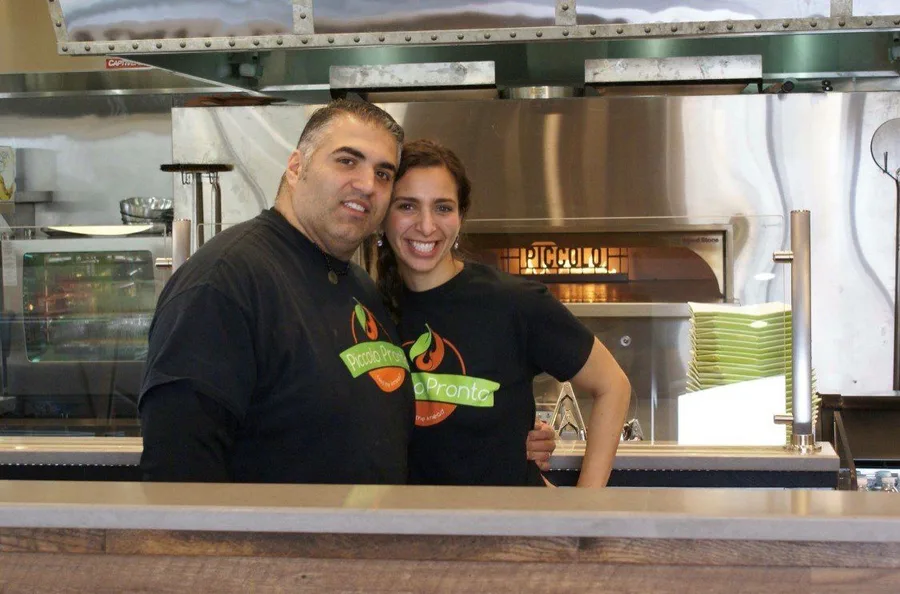 The Piccolo Trattoria family in front of the pizza oven