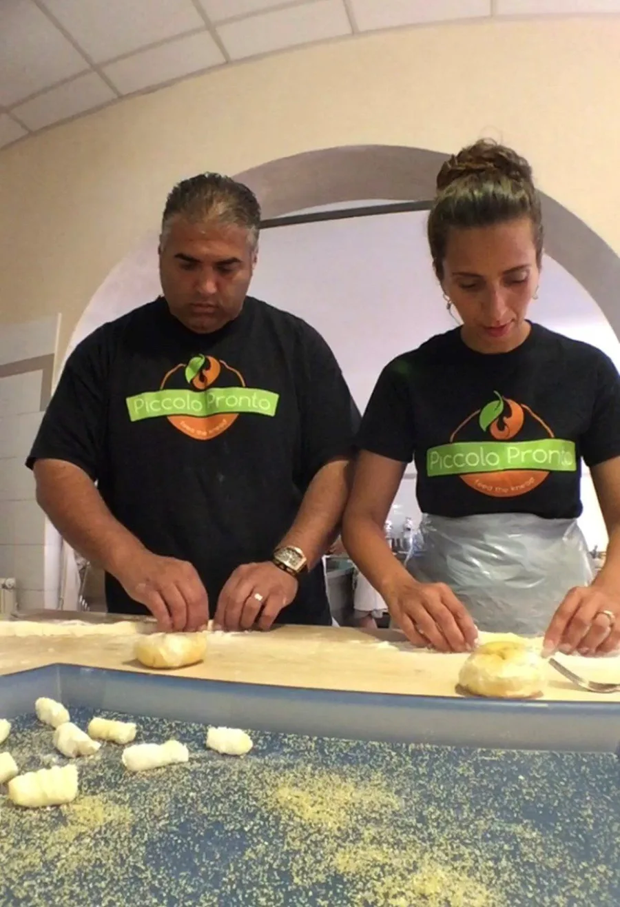 Piccolo Trattoria staff hand-rolling fresh potato gnocchi in the kitchen